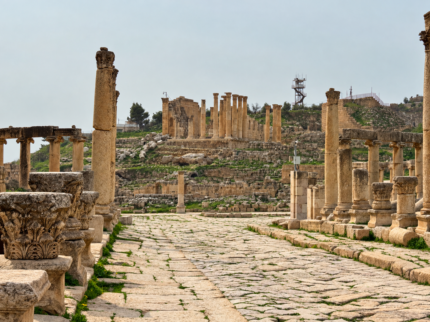 An empty paved avenue through ancient ruins